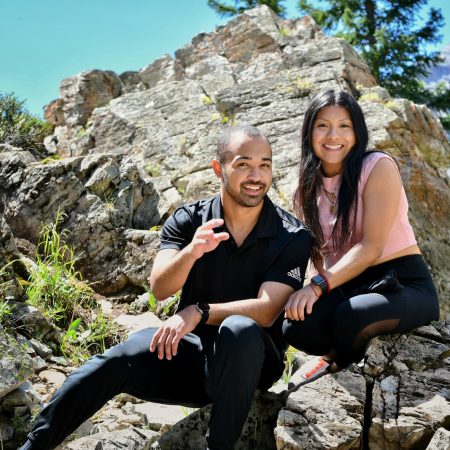 a man and a woman are sitting on rocks
